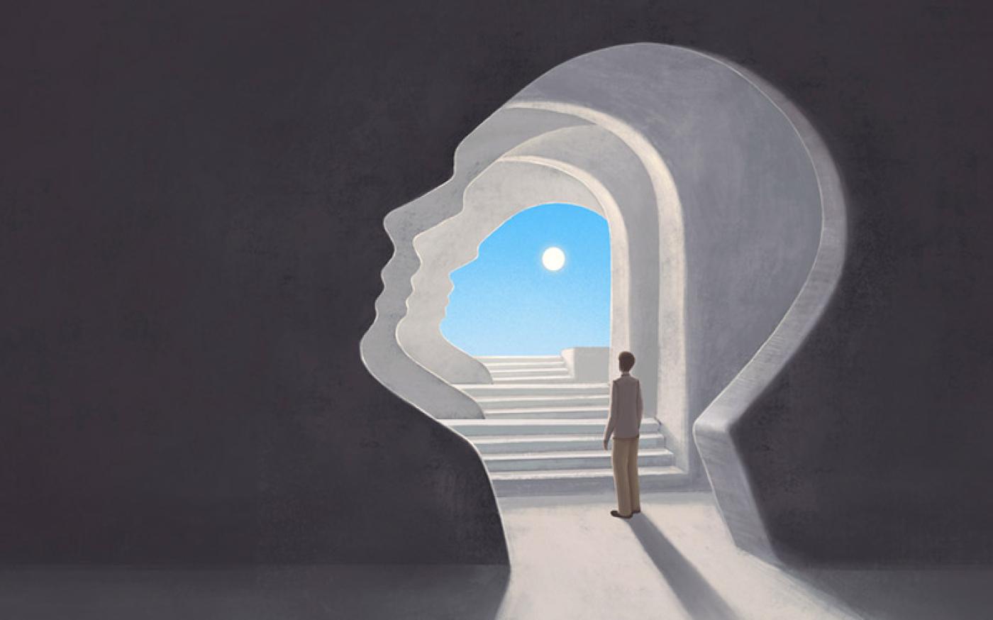 A person stands in a tunnel shaped like a human head, looking toward a bright sky and sun at the end of a staircase, symbolizing self-discovery or inner journey.