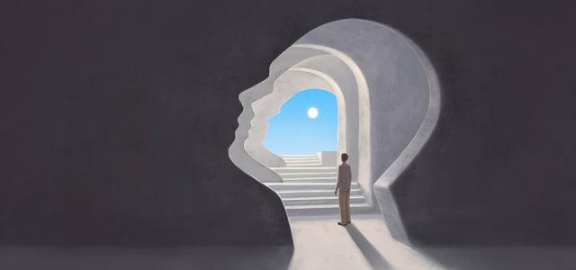 A person stands in a tunnel shaped like a human head, looking toward a bright sky and sun at the end of a staircase, symbolizing self-discovery or inner journey.
